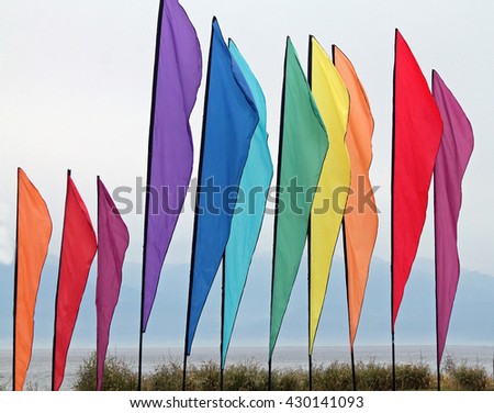 Similar – Colorful striped, closed parasol in close-up on the beach at sunset