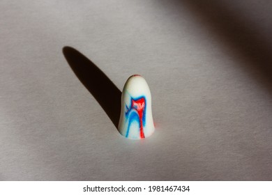 Multi-colored Foam Earplug On A White Background With Shadows