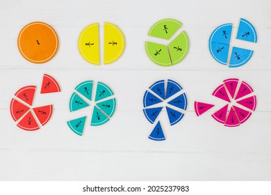 Multicolored fractions, blocks on white wooden table. Back to school, fun math, games for kindergarten, preschool education. - Shutterstock ID 2025237983