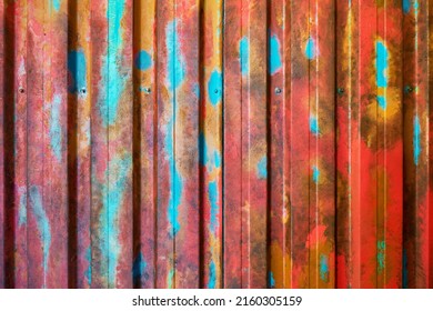 Multicolored grunge galvanized steel wall plate texture. Seamless container pattern with corrugated metal profiled panel and rivets.