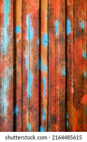 Multicolored grunge galvanized steel wall plate texture. Seamless container pattern with corrugated metal profiled panel and rivets.