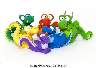 Multicolored handmade modeling clay dragons on white