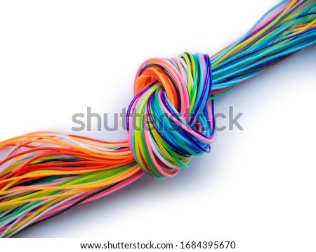 
multicolored knotted plastic cables als symbol for a bottleneck in data flow or communication isolated on white background