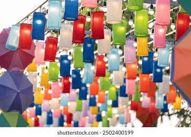 The multi-colored lanterns and umbrellas hanging in the park are beautifully designed, emitting soft light mixed with glittering light to create bokeh, creating an attractive and warm feeling. - Powered by Shutterstock