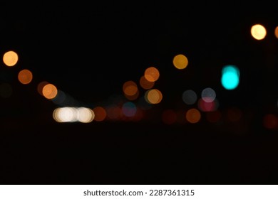 Multicolored lights of the night city. Glowing city road at night. - Powered by Shutterstock