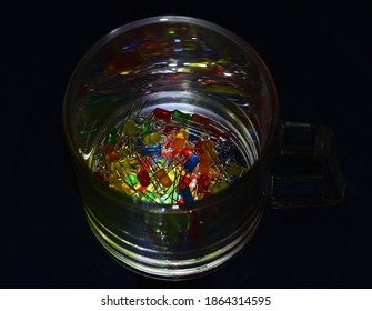 Multi-colored Low-power LEDs Are Poured Into A Round Glass Container.