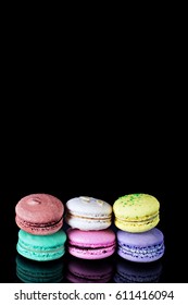 Multicolored macaroons  a black background.