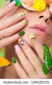 Multi-colored Manicure On Nails With A Design Of Butterflies. Decorated Glasses With Flowers And Butterflies On A Girl With Light Lipstick. Nail Art.