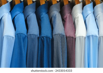 Multi-colored men's shirts on hangers in a store or store