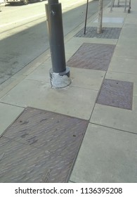 multicolored multitextured sidewalk and lamp post