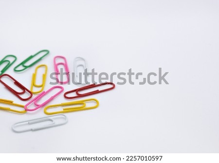 Multicolored paper clips on a white background
