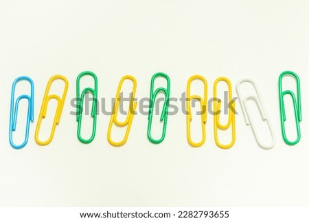 multi-colored paper clips on a white background