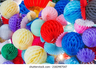 Multicolored paper pom-poms or honeycomb paper balls for the holiday decoration. Paper balls background