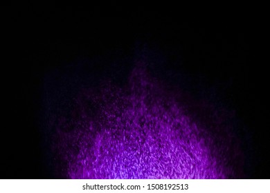 Multicolored particles explosion on black background. Colorful dust splatter on black background.