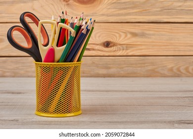 Multicolored pencils in metal holder.