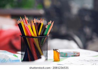 multicolored pencils in the office. Drawer for pens and pencils. Colored pencils in a pencil case. Colored pencils in black isolated case. concepts for concessions, school and office supplies