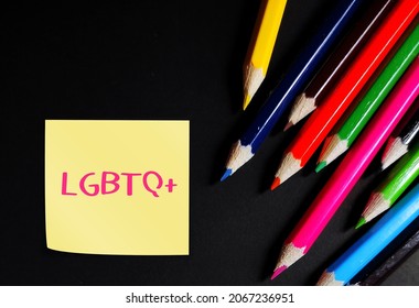 Multicolored pencils on black background with note written LGBTQ+, concept of diversity and equality - personal orientation gender identity, acronym of lesbian, gay, bisexual, transgender and queer  - Shutterstock ID 2067236951