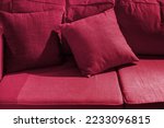 Multicolored pillow on sofa background. New 2023 trending PANTONE 18-1750 Viva Magenta color