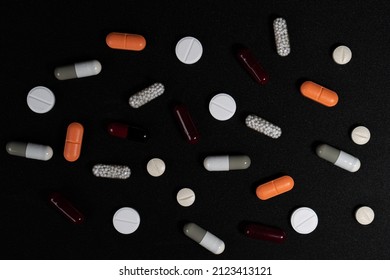 Multi-colored pills on a table. Medicine for depression, fever, stomach pain. - Shutterstock ID 2123413121