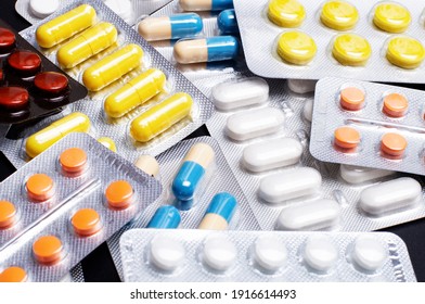 Multicolored pills, pharmaceuticals, antibiotics, medicines. Close-up of colorful antibacterial tablets. Banner on a medical theme. Medical concept