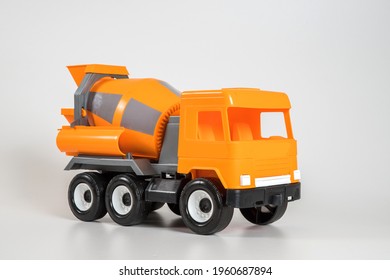 Multi-colored Plastic Children's Toy Cars On A White Background. Orange Concrete Truck.