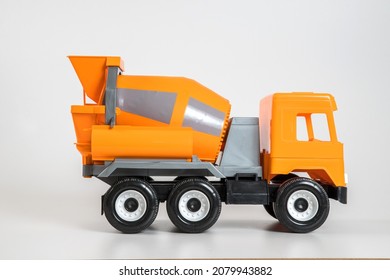 Multi-colored Plastic Children's Toy Cars On A White Background. Orange Concrete Truck.