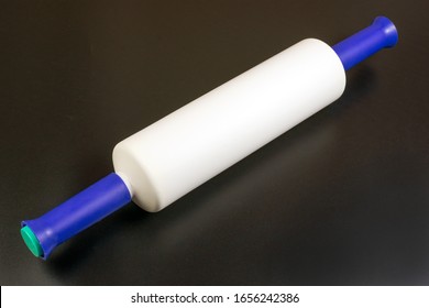 Multicolored Plastic Rolling Pin On A Black Background