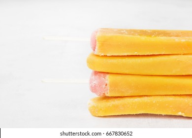 Multi-colored popsicles on a white background. Copy space. Food background
