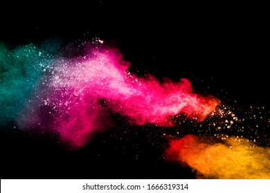 Multicolored powder explosion on black background.Colorful red yellow green splash cloud on background.