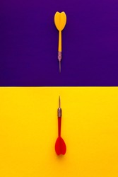 Multicolored Red Yellow Green Darts Arrows On Yellow Violet Blue Background. Flat Lay. View From Above. Copy Space. The Concept Of Hitting The Target, Dedication