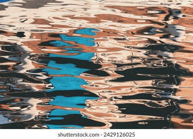 Multicolored reflections and highlights on the surface of sea water in sunny day. Abstract wallpaper or background