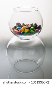 Multicolored Round Candy Sweets In A Round Spherical Vase Aquarium Creative Concept