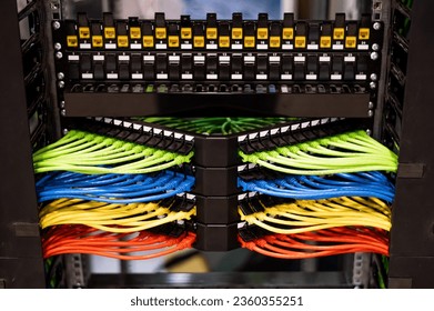 Multi-colored rows of network cables are connected to the system