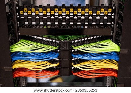 Multi-colored rows of network cables are connected to the system