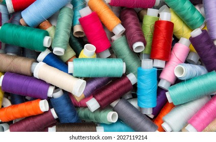 Multicolored sewing threads. Colourful thread spools.