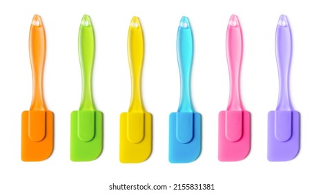 Multicolored silicone cooking spatula set isolated on white background. Colorful rubber spatulas with handle for confectionery, bakery and pastry. Heat resistant kitchenware tool. Top view.