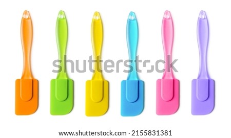 Multicolored silicone cooking spatula set isolated on white background. Colorful rubber spatulas with handle for confectionery, bakery and pastry. Heat resistant kitchenware tool. Top view. Сток-фото © 