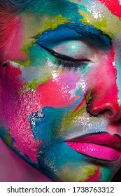 Multicolored skin, difficult to identify. Creative makeup and drawing on the face. Modern fashion look, creative and unusual style