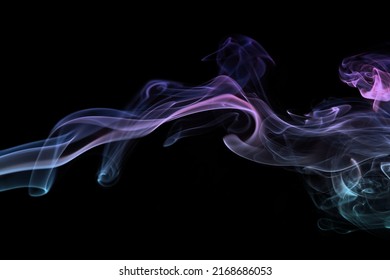 Multicolored smoke for aromatherapy and relaxation on black background, beautiful swirled puffs of smoke. Pink, purple and turquoise gradient colors of dense smoke, decorative multicolour smoke curls