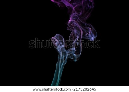 Multicolored smoke for aromatherapy and relaxation on black background, beautiful swirled puffs of smoke. Pink, purple and turquoise gradient colors of dense smoke, decorative multicolour smoke curls