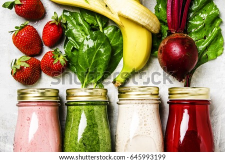 Multicolored smoothies and juices from vegetables, fruits and berries, food background, top view