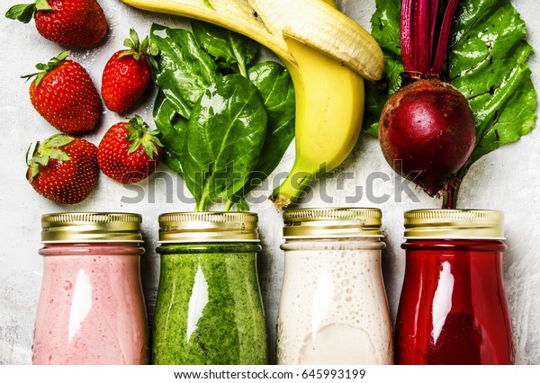 Multicolored smoothies and juices\
from vegetables, fruits and berries, food background, top\
view