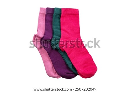 Multi-colored socks on a white background. View from above. Socks are scattered on a bright background. Socks of different types and sizes. Colorful cotton socks.