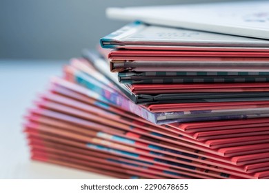 multi-colored spines of photo books close-up, partial blur