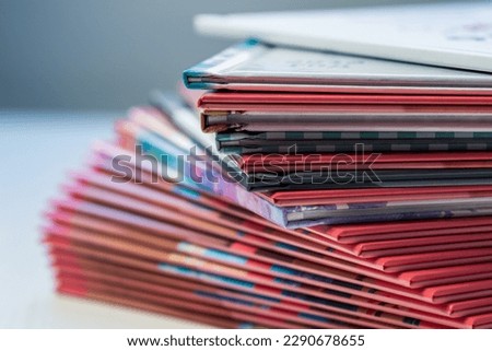 multi-colored spines of photo books close-up, partial blur