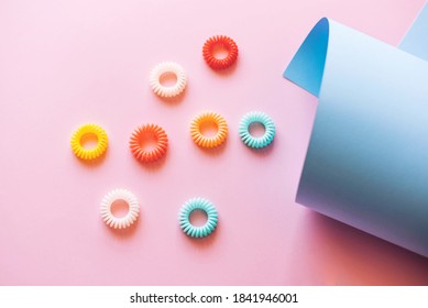 Multicolored Spiral Hair Ties On A Pink Background. 