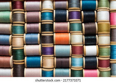 Multi-colored spools of thread close-up. Sewing threads multicolored background closeup