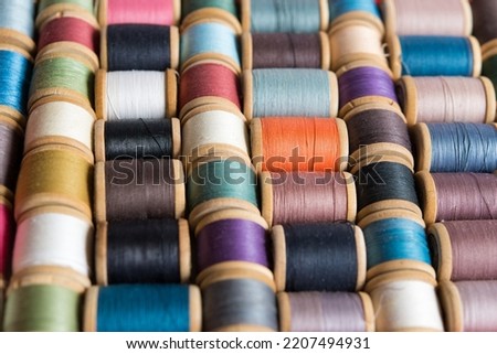 Multi-colored spools of thread close-up. Sewing threads multicolored background closeup