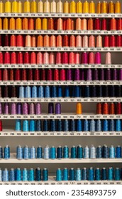 Multi-colored spools of thread on the shelf