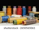 Multicolored spools thread. Spools of multi-colored threads lies on white table, close-up shot photo